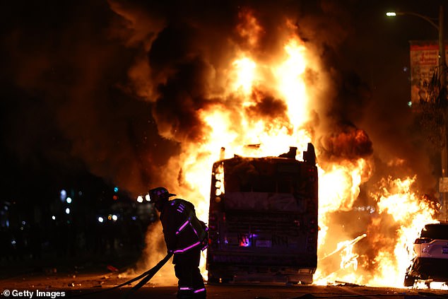 Firefighters tried to battle the blaze after a bus was set on fire during the festivities