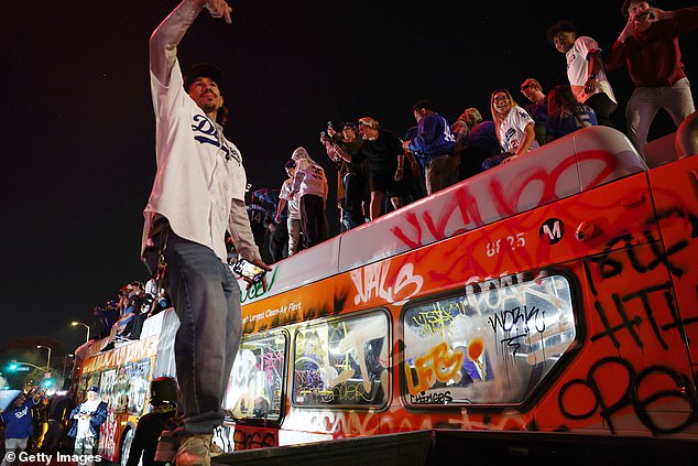 Dodgers fans celebrated at Echo Park in Los Angeles on top of a bus