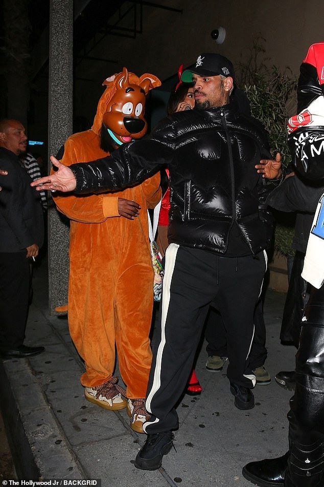 Chris Brown, 35, went for an equally casual look as he arrived at the star-studded spooky party