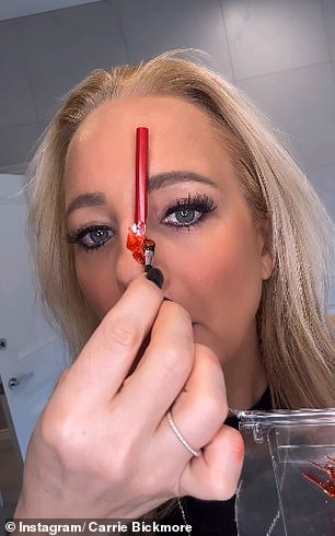 In the video, Carrie placed one half of the broken pencil in her nostril while the other was on the nose