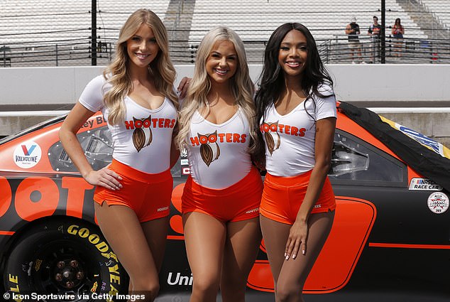 The chain restaurant is known for its scarce cad waitresses, who are here representing the company at a 2021 Nascar event