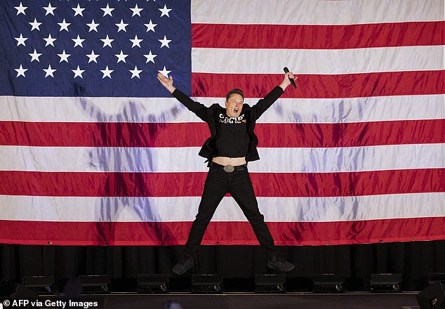 Tesla and SpaceX CEO Elon Musk jumps on stage as he arrives to speak at a town hall event hosted by America PAC in support of former US President and Republican presidential candidate Donald Trump at the Greater Philadelphia Expo Center in Oaks, Pennsylvania, on October 18. 2024