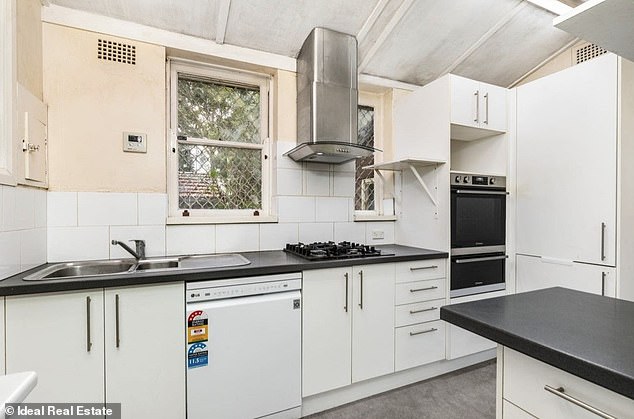 The home's kitchen (pictured) also shows mold or smoke stains, or possibly both