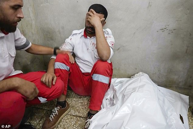 The Palestinian ambulance worker sat in the morgue next to Samira's body with his head in his hands