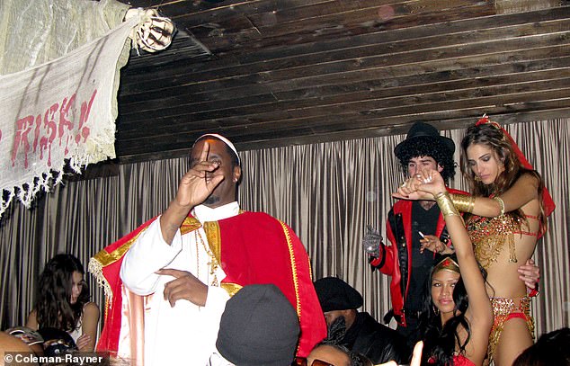 The musician, real name Sean Love Combs - transformed into the head of the Catholic Church in a white skullcap, cassock, red shoulder-length cape and multiple crucifixes - his ex-girlfriend Cassie is seen below right in a Wonder Woman outfit