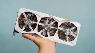 An ASRock Steel Series Radeon RX 7900 GRE is held in a man's hand.