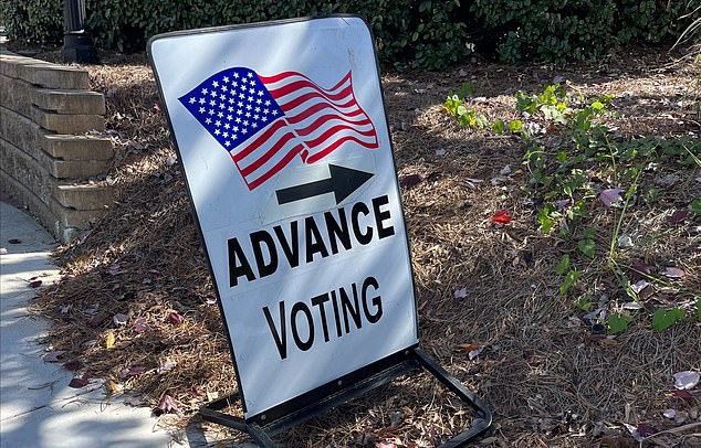 An early voting sign directing people where they can cast their ballot at a polling place before Election Day in Georgia. A record number of people are participating in early voting in the battleground state