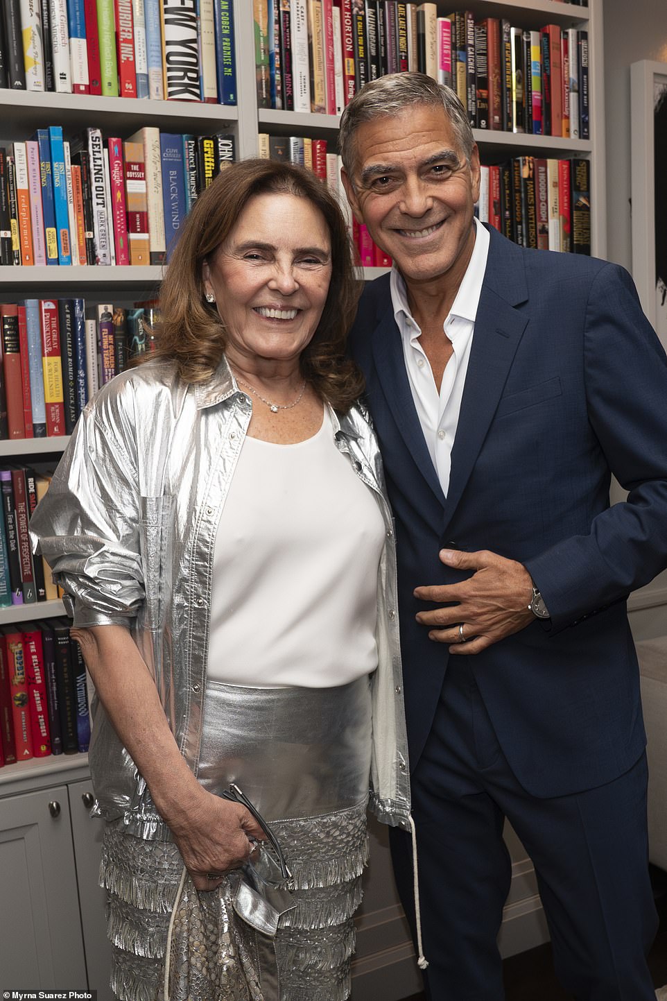 Clooney also posed with a woman in a dynamic silver suit with a white shirt