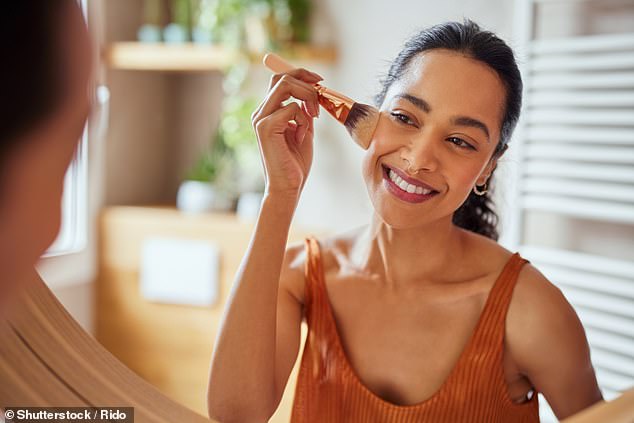 Apparently being ugly is more than being unhappy in appearance (stock photo of a woman applying makeup)