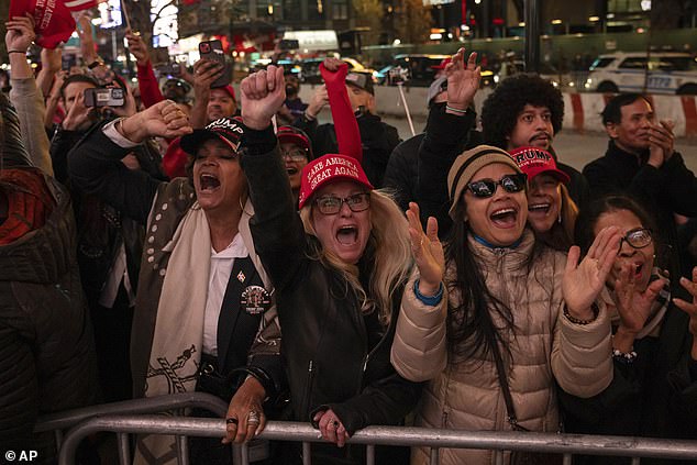 Supporters of former Republican presidential candidate Donald Trump react as Elon Musk takes the stage during a campaign rally at Madison Square Garden, Sunday in New York