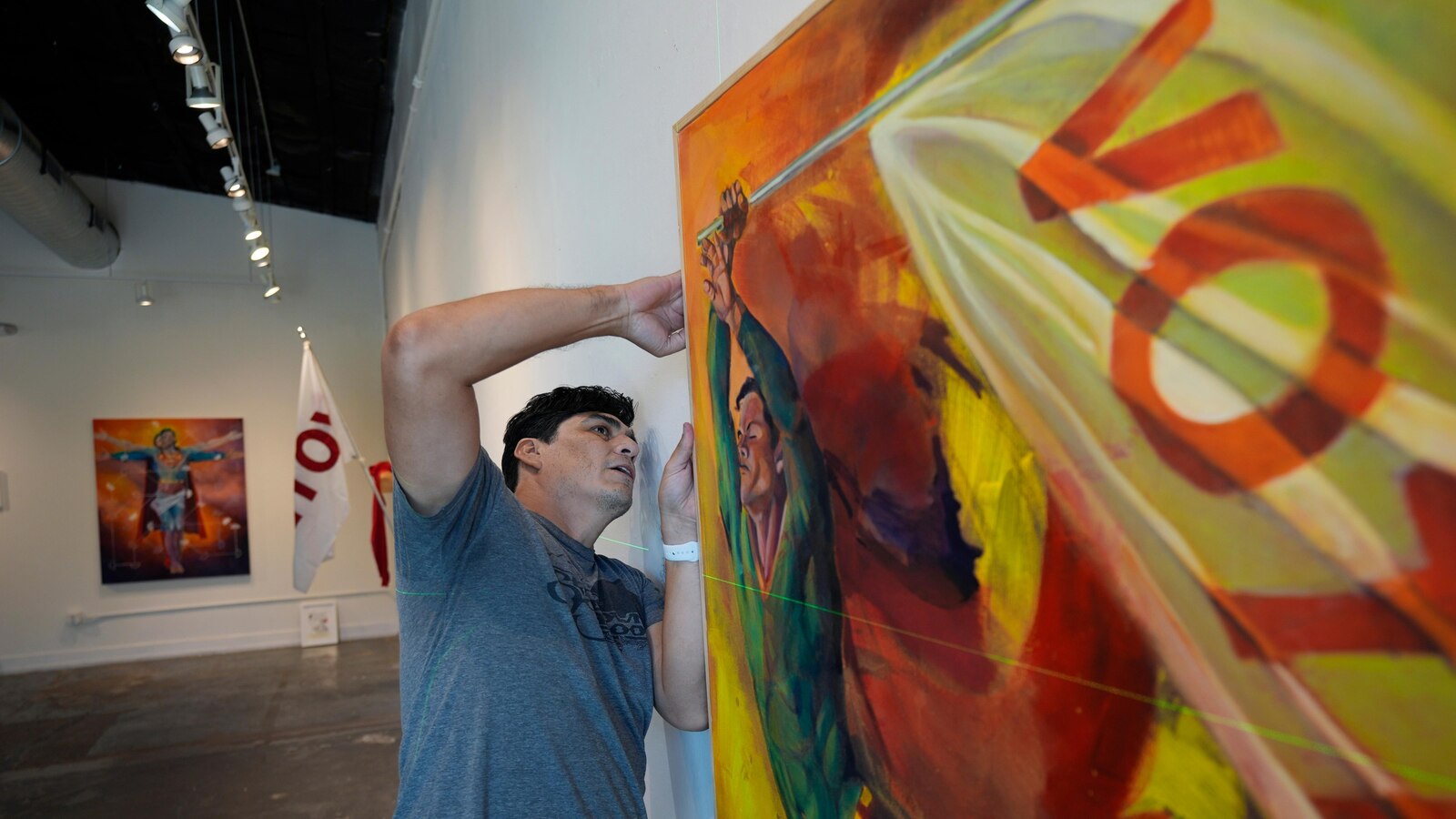 AP PHOTOS: An artist summons Superman to remind people the power of voting