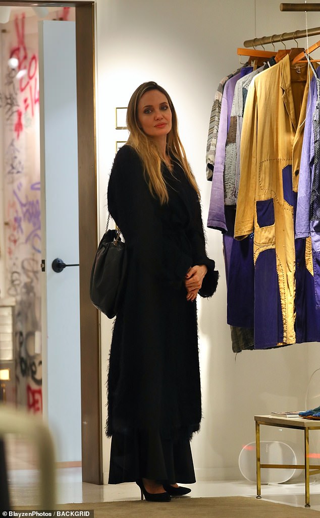 The Maria star cut an elegant figure in a stylish black coat, underneath which she wore a silk black dress