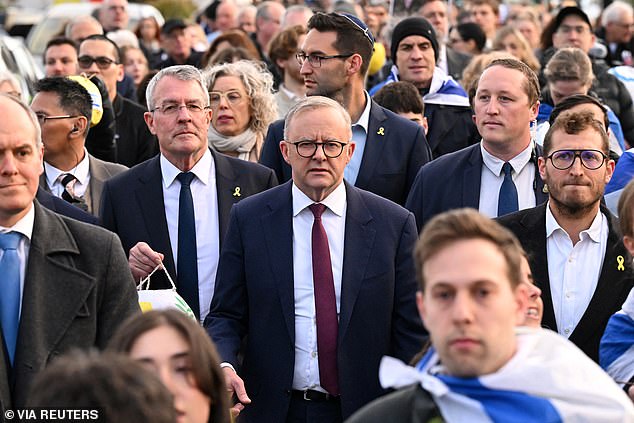 Anthony Albanese (pictured center) was jeered in Melbourne at a commemoration of the first anniversary of the October 7 massacre in Israel