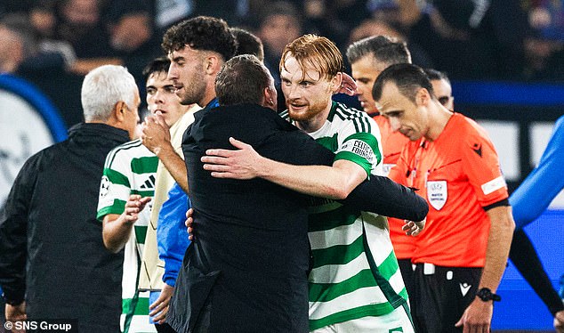 Liam Scales is congratulated by his manager, Brendan Rodgers, for his contribution to the clean sheet