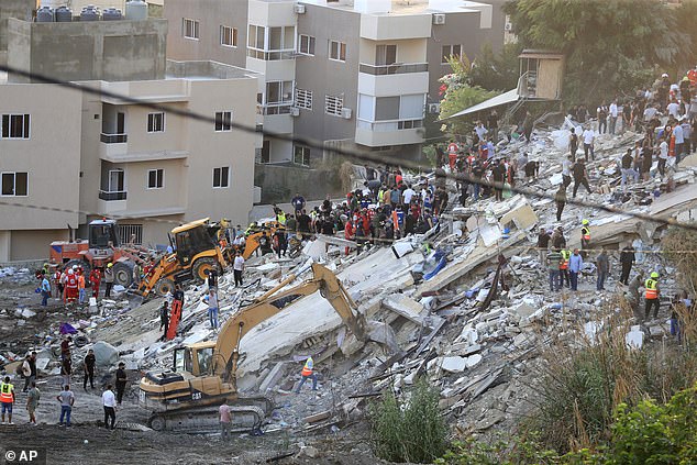 Rescue teams search for victims after an Israeli airstrike hit two adjacent buildings, in the Ain el-Delb neighborhood east of the southern port city of Sidon, Lebanon