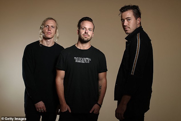 Australian music star Jon George of popular dance group Rüfüs Du Sol has revealed he has stopped living in Los Angeles after being met with a hail of bullets during a drive-by shooting. Pictured: Jon (center) with band members Tyrone Lindqvist (L) and James Hunt (R)