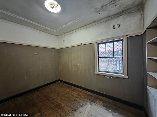 This photo shows a bedroom with mold in it, but the owner wants up to $800 a week in rent for the house