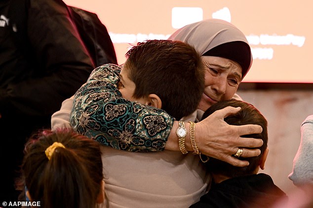 The Department of Foreign Affairs and Trade (DFAT) said a total of 1,425 Australians had returned on flights from Cyprus to Sydney on Thursday (pictured, a post-flight reunion)