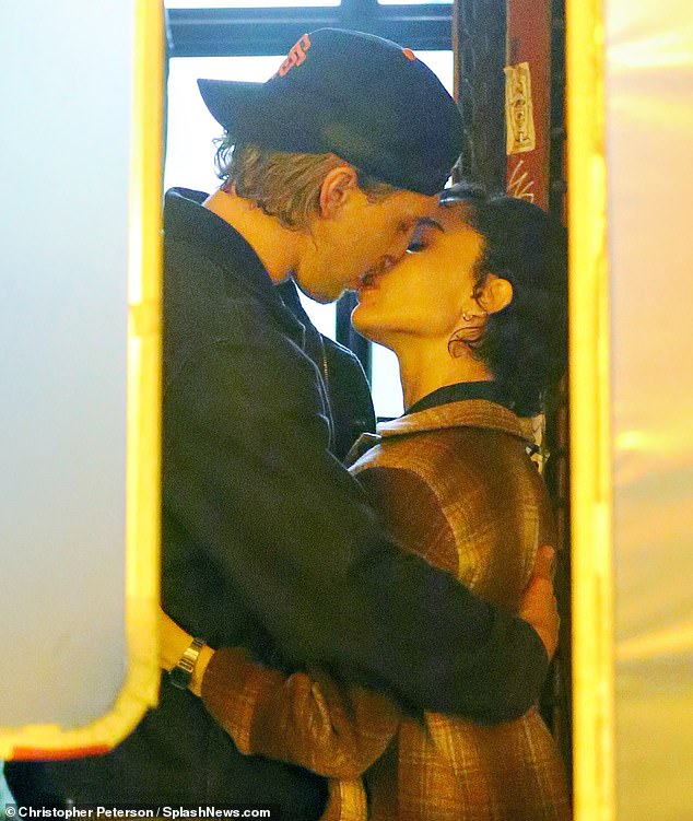 The actors were both wearing heavy coats and had their arms around each other as they locked lips for the cameras