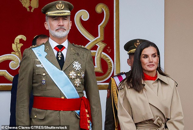 King Felipe of Spain (pictured, left) and Queen Letizia (pictured, right) were photographed during a military parade known as Dia de la Hispanidad in Madrid on Saturday.