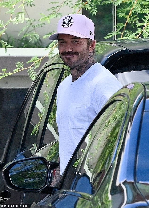 David Beckham smiles as he arrives to view his newly purchased £60 million Miami mansion