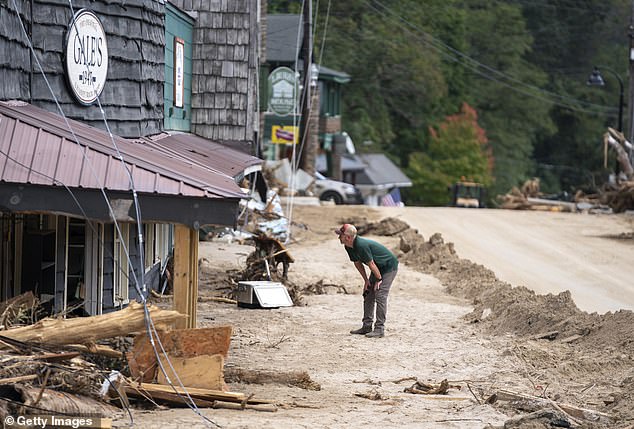 A member of law enforcement investigates flood damage in the aftermath of Hurricane Helene on October 2, 2024 in Chimney Rock, North Carolina. According to published reports, the death toll in the southeastern US has risen above 180 people as a result of the storm, which made landfall as a Category 4 storm last Thursday. Mayorkas says FEMA is running out of money to help