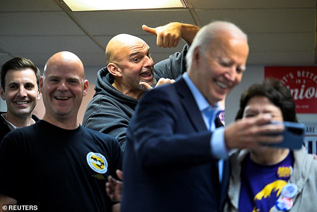 Pennsylvania Sen. John Fetterman (center) photobombed a selfie that President Joe Biden (second from right) took with a phone banking volunteer at the Steamfitters Technology Center in Pittsburgh on Saturday