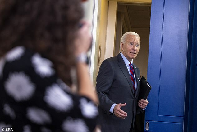 US President Joe Biden jokes with the news media as he leaves the daily briefing in the White House press conference room