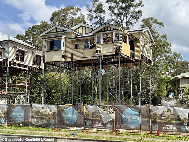 A Brisbane construction project has been dubbed the 'super Queenslander' after two houses had to be lifted stories high to make way for construction (pictured)