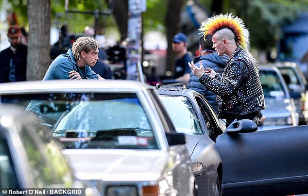 Dressed in a studded leather jacket and sporting a huge multi-colored mohawk, the actor in question was dressed in character while shooting a new film with Austin Butler