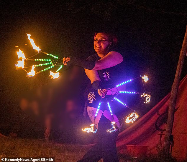 Beatrice Francovschi,32, (pictured fire dancing) traveled to a festival in Indiana, USA, for a fun weekend getaway and to meet friends