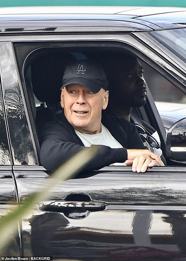 Bruce Willis, 69, smiled during a Sunday drive in Studio City, California, as the actor continues his health battle with aphasia and dementia