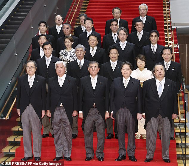 The photos were released by the Japanese government to commemorate the first cabinet meeting. In the photo you can see Japan's recently installed Prime Minister Shigeru Ishiba standing shoulder to shoulder with his ministers, but with a minor wardrobe malfunction