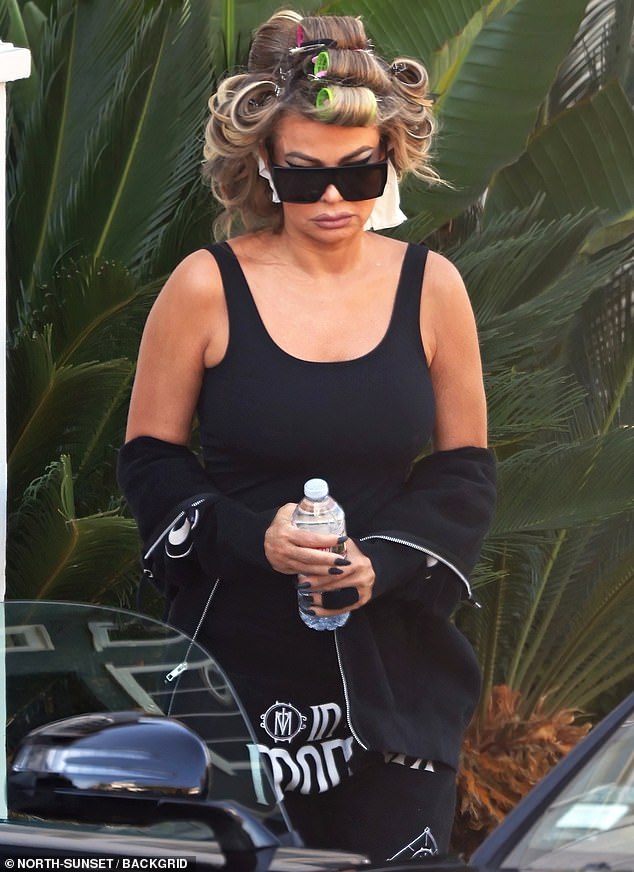 Carmen Electra looked glum as she showed up in Los Angeles - after a bizarre podcast interview that left fans concerned