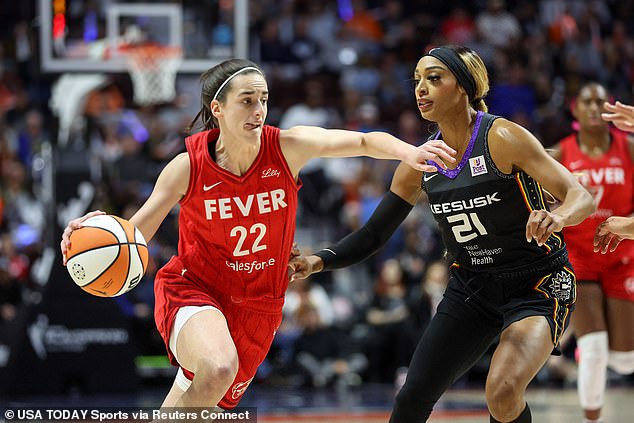 Fever guard Caitlin Clark (22) drives to the basket defended by Suns guard DiJonai Carrington