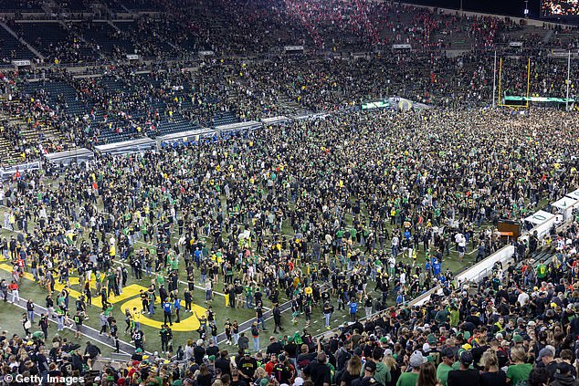 Oregon Ducks fans storm the field in Eugene after beating the Ohio State Buckeyes 32-31