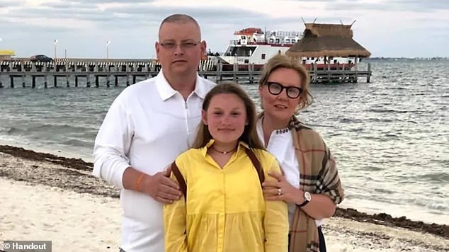 Richard Pawuski, 49, has died after a five-year battle with eastern equine encephalitis. He is pictured above with his wife Malgorzata and daughter Amelia