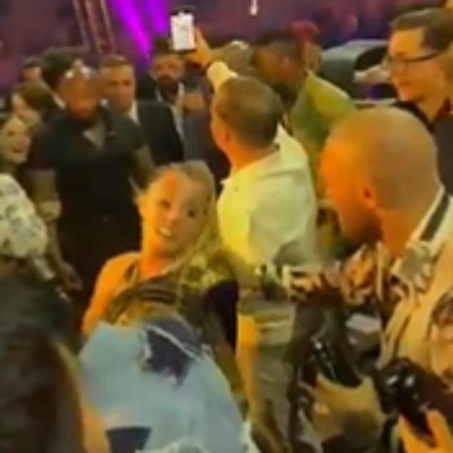 Conor McGregor's fiance was forced to intervene to stop the UFC star from dancing with another woman (left)