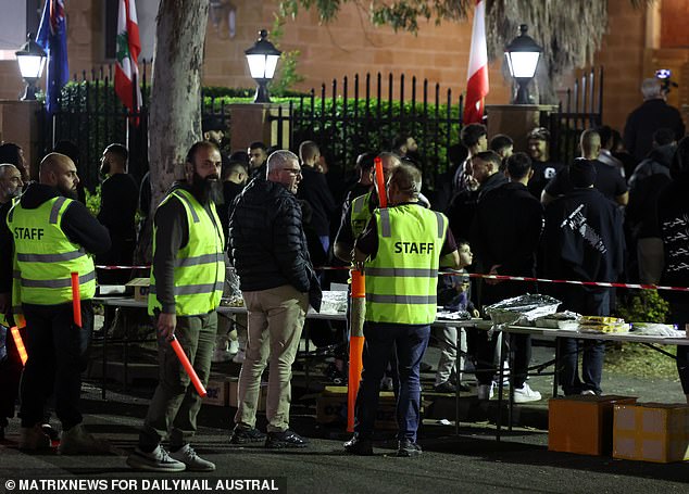 Men in high-vis jackets manned tables outside the mosque as they provided food and water to attendees (pictured)