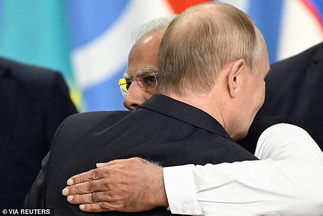 President Modi hugs Putin at the end of the conference. Modi warned that the meeting should not be seen as a united front against the West