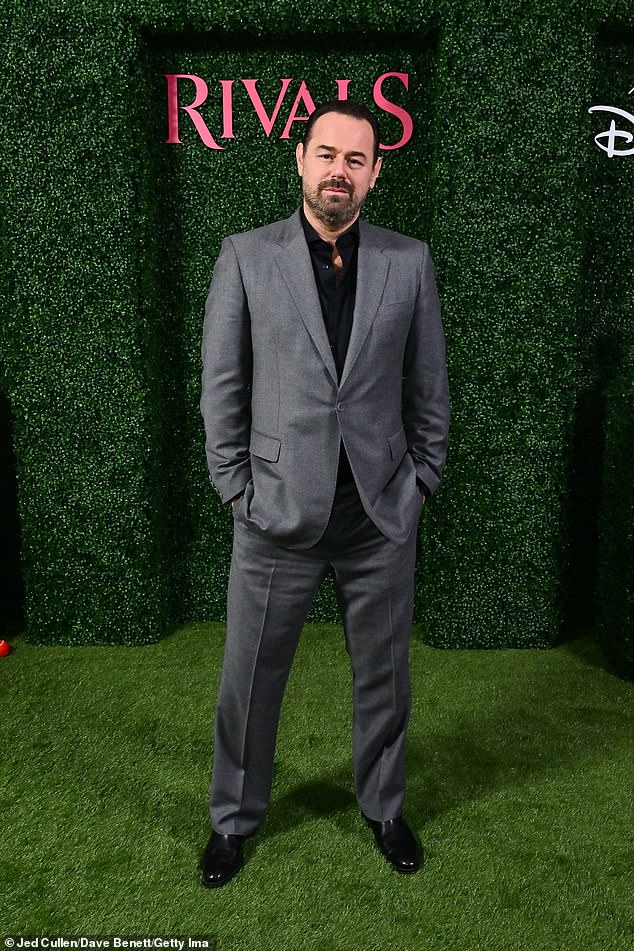 The actor cut a dapper figure in a gray suit and black shirt as he hit the red carpet