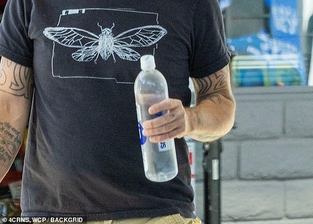 The Foo Fighters singer - who was seen for the first time since admitting to cheating on his wife Jordyn Blum on Tuesday - grabbed a few things at a market before also stopping by a gas station.