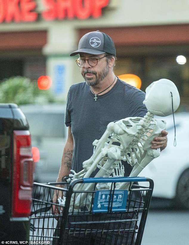 Getting ready for the upcoming holiday, the rocker pushed a cart full of decorations, including two full-size skeletons