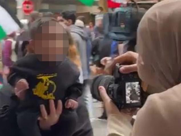 Chilling photos have emerged of a toddler wearing a shirt with a Hezbollah flag printed on the front at a pro-Palestine rally