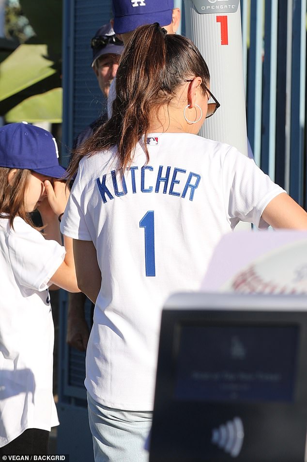 Mila proudly displays 'Kutcher' on the back