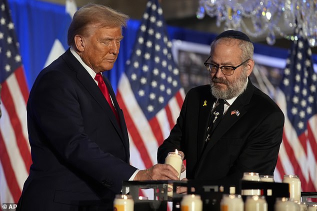 Republican presidential candidate, former President Donald Trump, lights a candle with Rabbi Yeshuda Kaploun during an event marking one year since the October 7 Hamas attack on Israel, Monday, October 7, 2024, in Miami