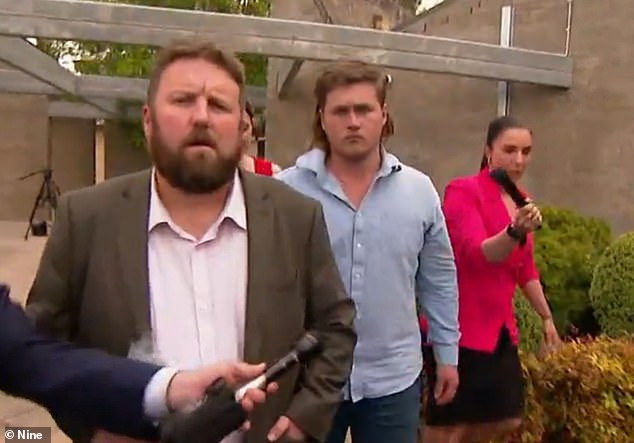 Callum Thorne, 22, (center in blue shirt) has been released on bail after police arrested him and charged him with reckless driving