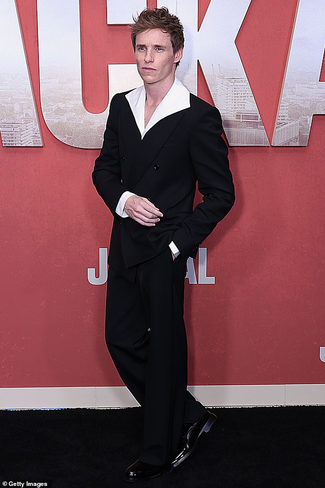 Eddie – who is being dubbed by fans as the 'next James Bond' – also walked the red carpet in black trousers and a matching blazer and white shirt with dramatic collars underneath