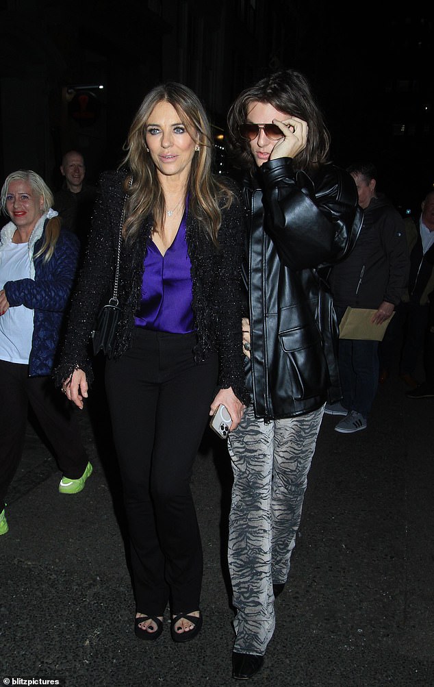 Elizabeth Hurley, 59, and her son Damian, 22, were in good spirits as they supported friend Joan Collins in her One Night Only show at the Adelphi Theater in London on Tuesday.