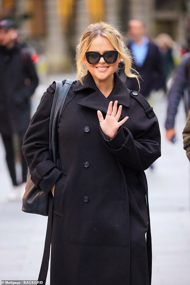 Emily Atack looked chic in a black trench coat as she left the Heart Radio studios on Monday